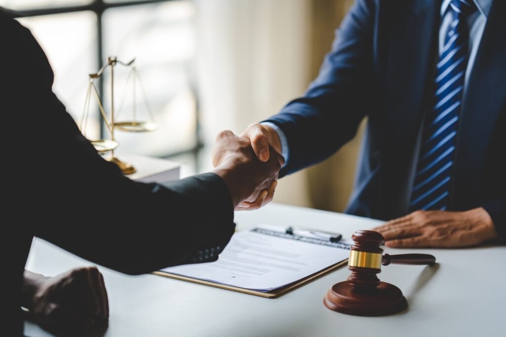 Portrait of lawyers agreeing holding hands in lawyer office giving advice and advice on case consult